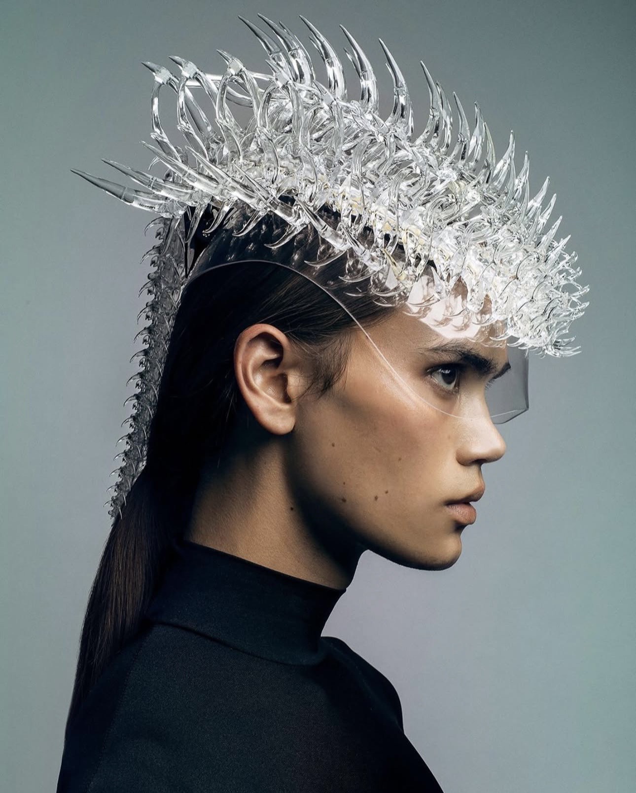 Editorial profile portrait with sculptural headpiece