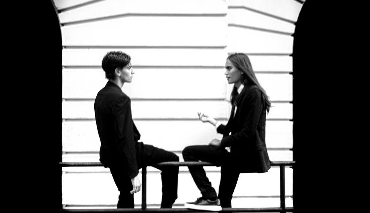 Black-and-white editorial dialogue scene